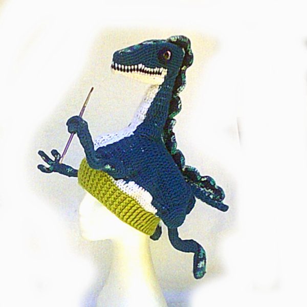 Grabosaurus, a poseable crochet dinosaur hat who can hold things for his wearer