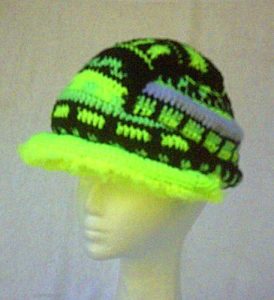 The crochet hardhat has a double 'shell' with a padded, wired brim, padded raised border and central ridge, and a 'reflective' safety stripe (mohair and metallic mix yarn).