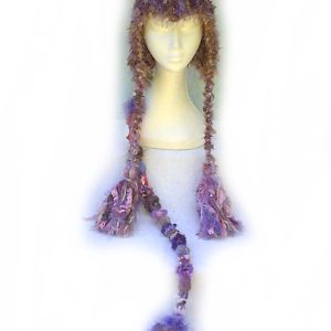 Mushroom Magic Imp Hat, a crochet ear flap hat with tiny horns and a long pointed tail.
